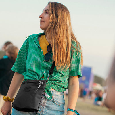 Pacsafe® GO anti-theft crossbody pouch (lifestyle)